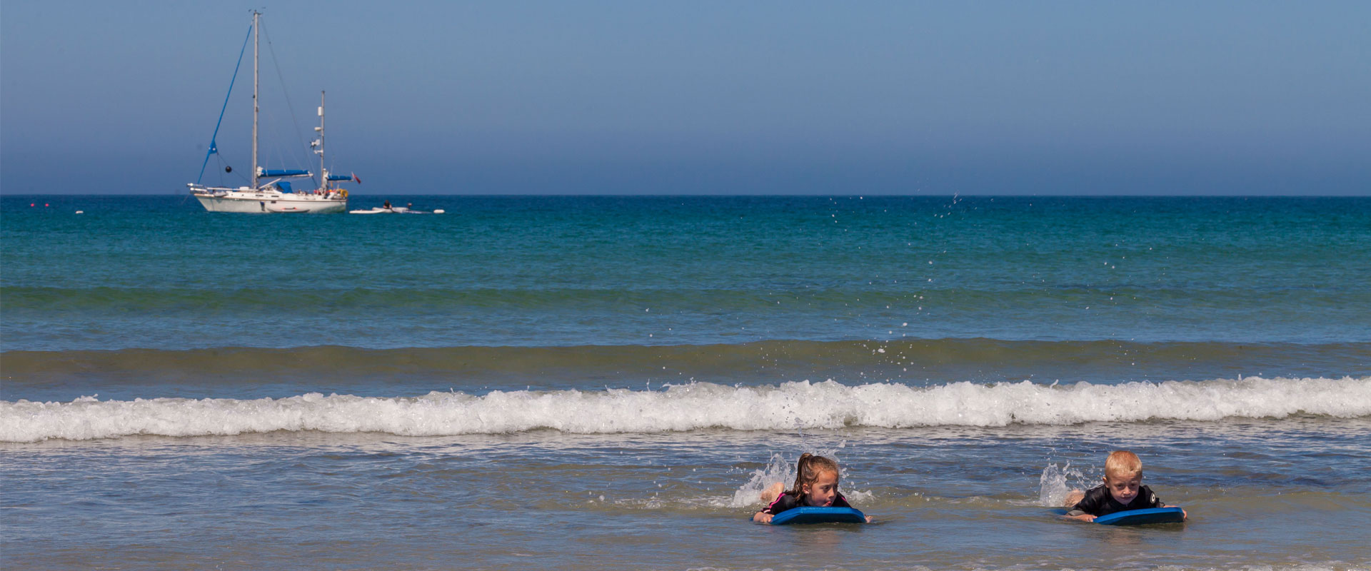 Children wave-boarding - Images courtesy of VisitGuernsey